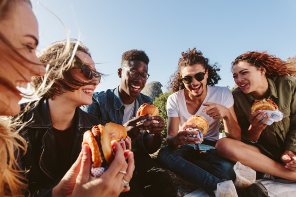 a group of friends share a picnic in a park