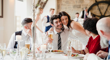 A bride greeting guests at a wedding reception