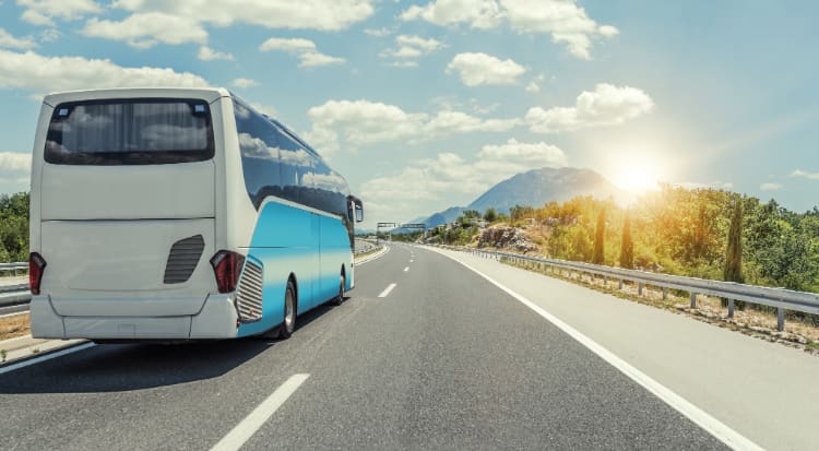 an unbranded charter bus drive on an open highway